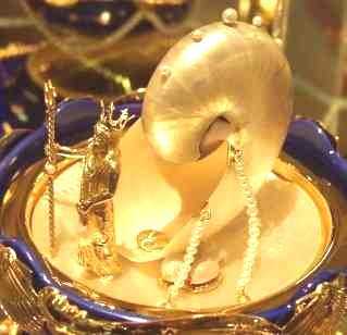 The surprise within - a nautilus shell flowing with a cornucopia of pearls,  the entrance to the shell is guarded by the King of the Oceans, Neptune.